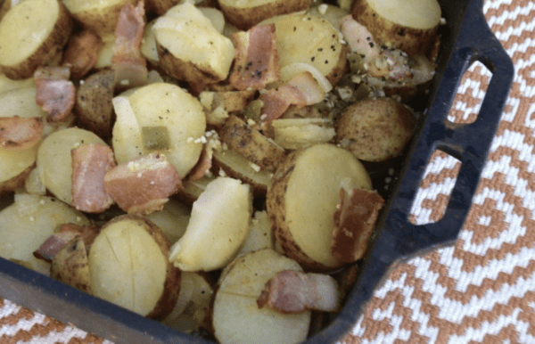 Baked potato slices with bacon and seasonings.